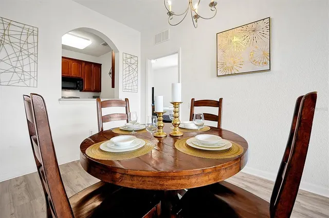 a dining room with furniture and wooden floor