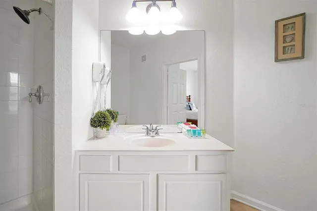 a bathroom with a sink vanity and a mirror