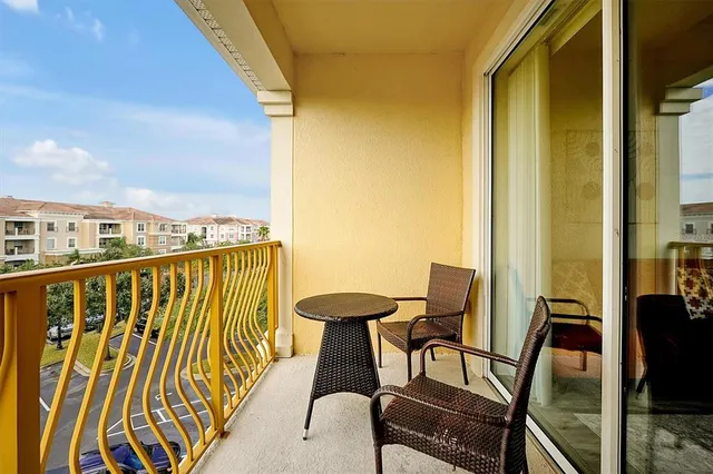 a balcony with table and chairs
