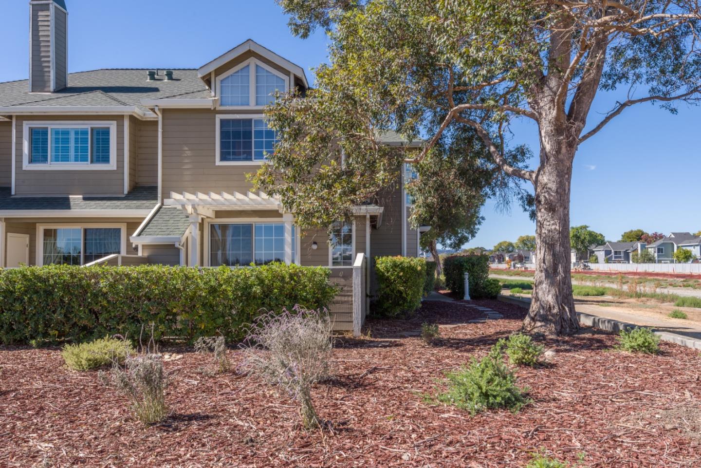 100 Farallon Drive Belmont, CA 94002 - Photo 2 of 29 a front view of a house with garden and trees
