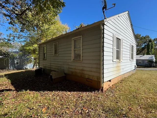 a view of a house with a yard and sitting area