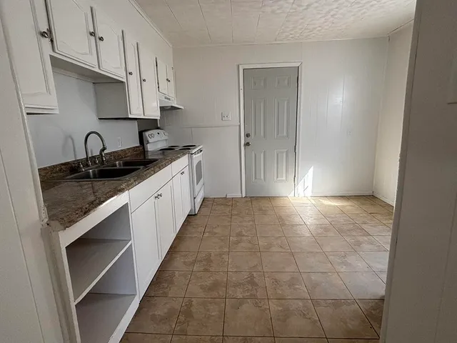 a kitchen with a sink and cabinets