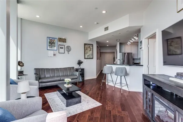a living room with furniture and a wooden floor