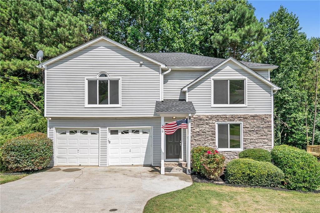210 Hillcrest Ridge Canton, GA 30115 - Photo 1 of 1 a front view of a house with a yard and garage
