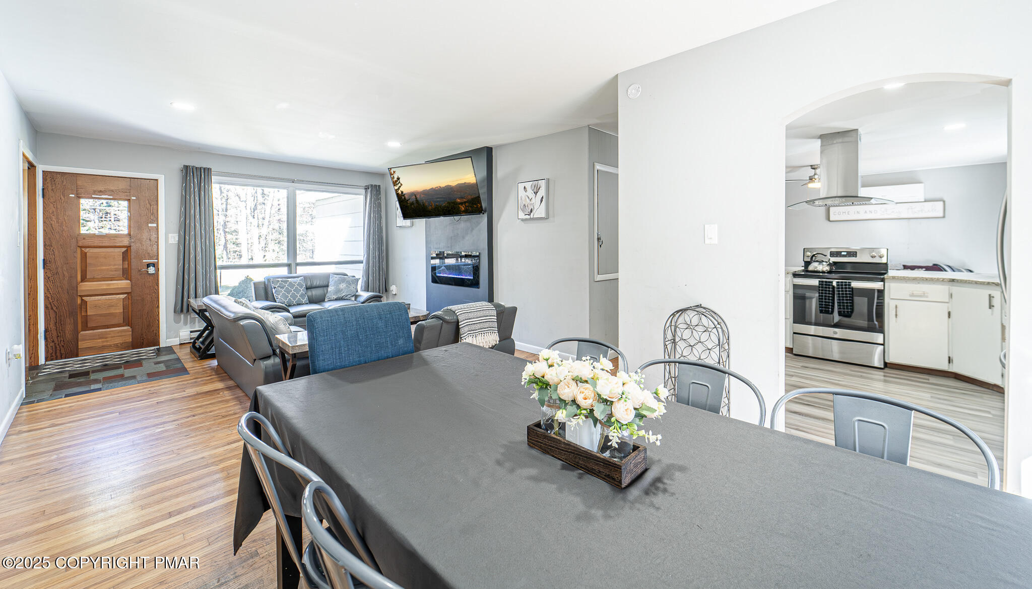 2332 Highway 940 Pocono Summit, PA 18346 - Photo 19 of 65 a living room with furniture a flat screen tv and a table