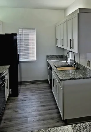 a kitchen with a refrigerator stove and wooden cabinets