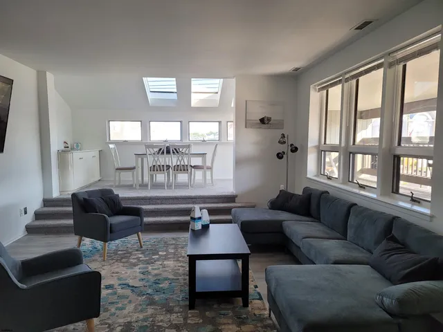 a view of a dining room with furniture and a floor to ceiling window