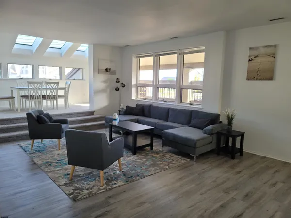 a view of a dining room with furniture and a floor to ceiling window