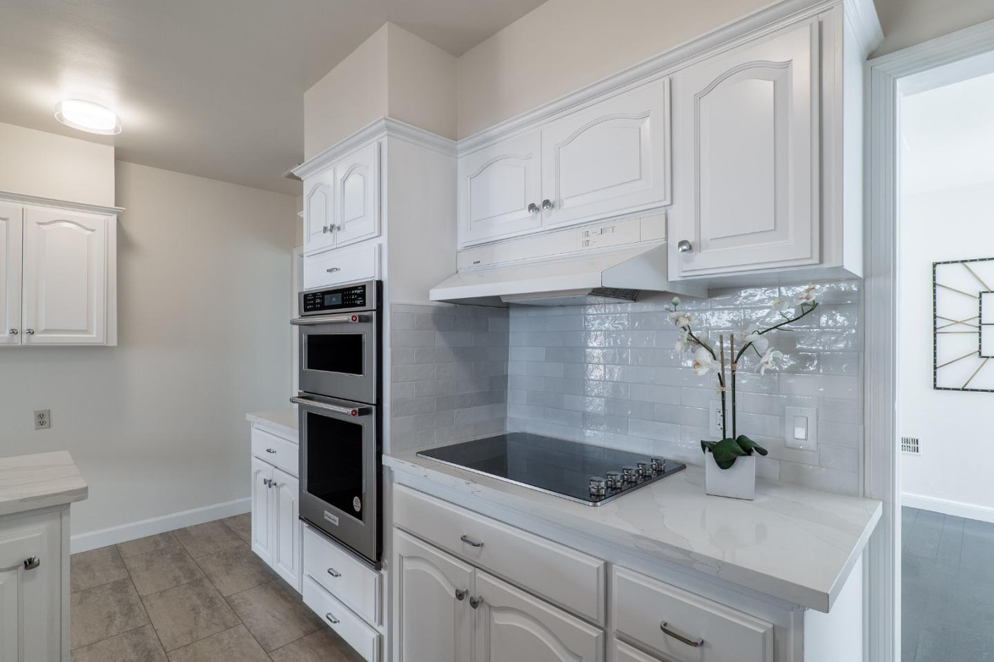 340 Dwight Road Burlingame, CA 94010 - Photo 12 of 29 a kitchen with white cabinets and white appliances