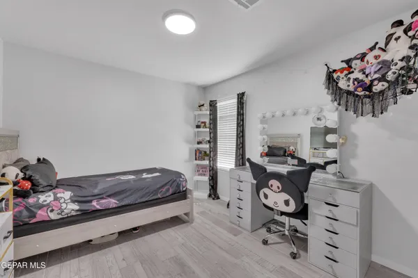 a bedroom with a workspace
