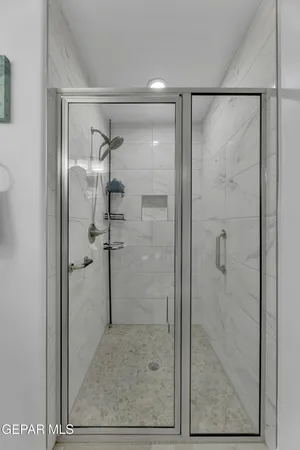 a bathroom with a glass shower door