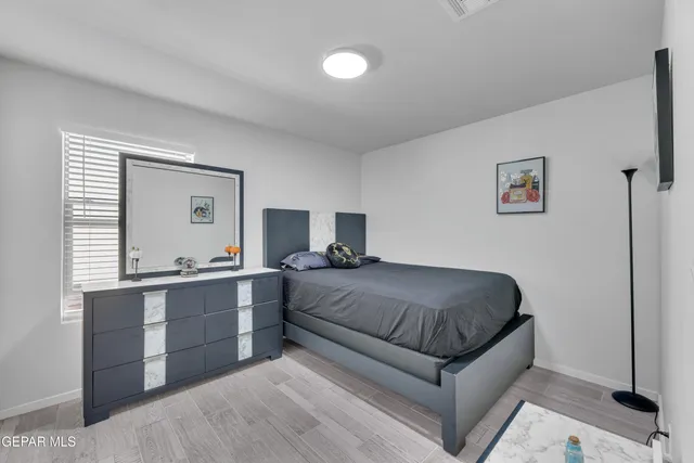 a living room with a bed and a dresser