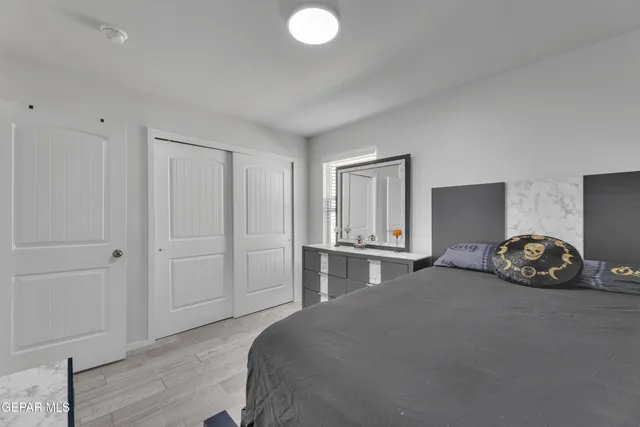 a bed room with a bed and a chair