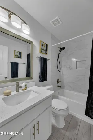 a bathroom with a sink a toilet and a mirror