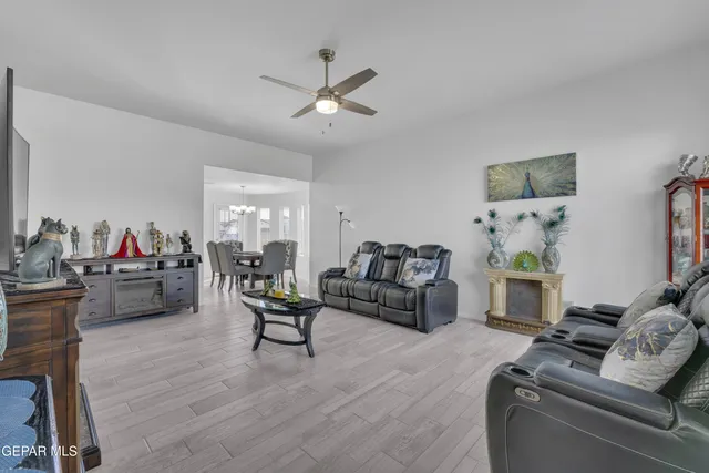 a living room with furniture and a wooden floor