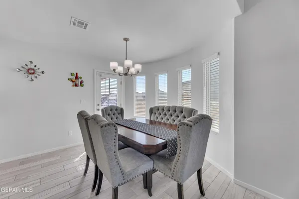 a view of a dining room with furniture and chandelier