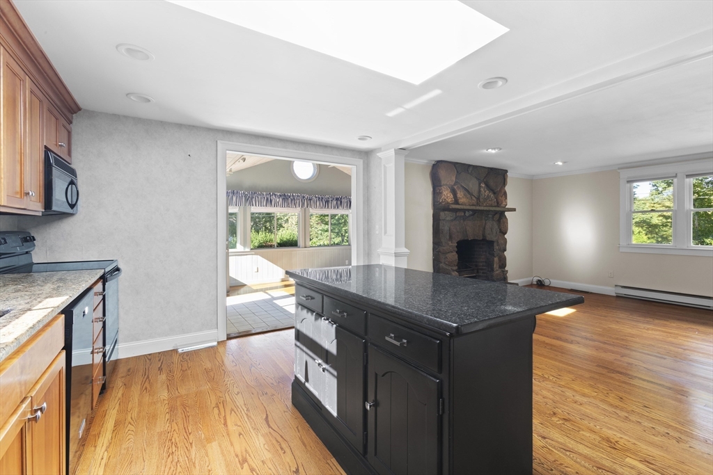 152 Coburn Road Berlin, MA 01503 - Photo 11 of 40 a kitchen with granite countertop a stove a sink a counter space and cabinets
