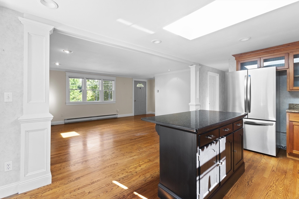 152 Coburn Road Berlin, MA 01503 - Photo 13 of 40 a kitchen with stainless steel appliances granite countertop a refrigerator a stove and a wooden floors
