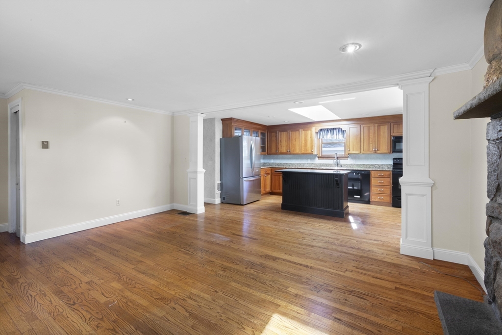 152 Coburn Road Berlin, MA 01503 - Photo 15 of 40 a view of a kitchen with a sink and a fireplace