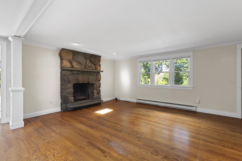 152 Coburn Road Berlin, MA 01503 - Photo 17 of 40 an empty room with windows and fireplace