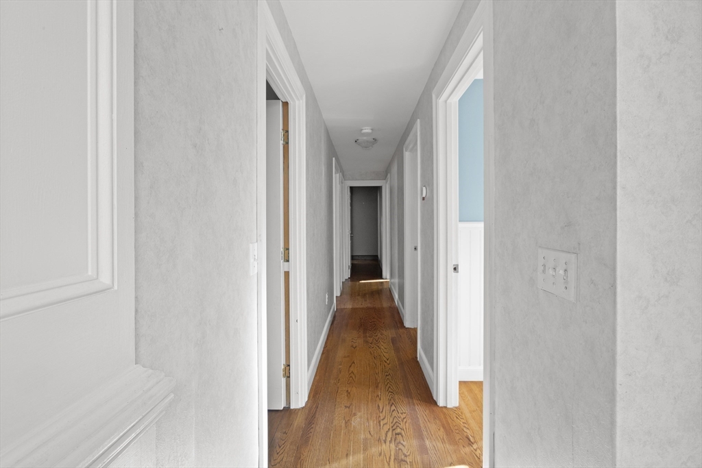 152 Coburn Road Berlin, MA 01503 - Photo 18 of 40 a view of a hallway with wooden floor and staircase