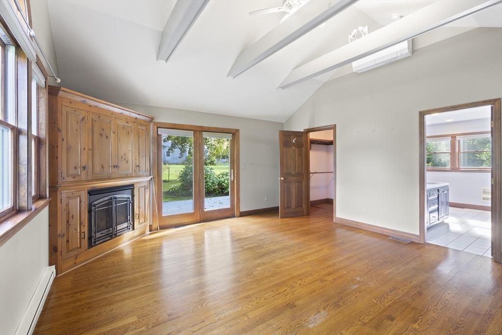 152 Coburn Road Berlin, MA 01503 - Photo 20 of 40 wooden floor fireplace and windows in an empty room