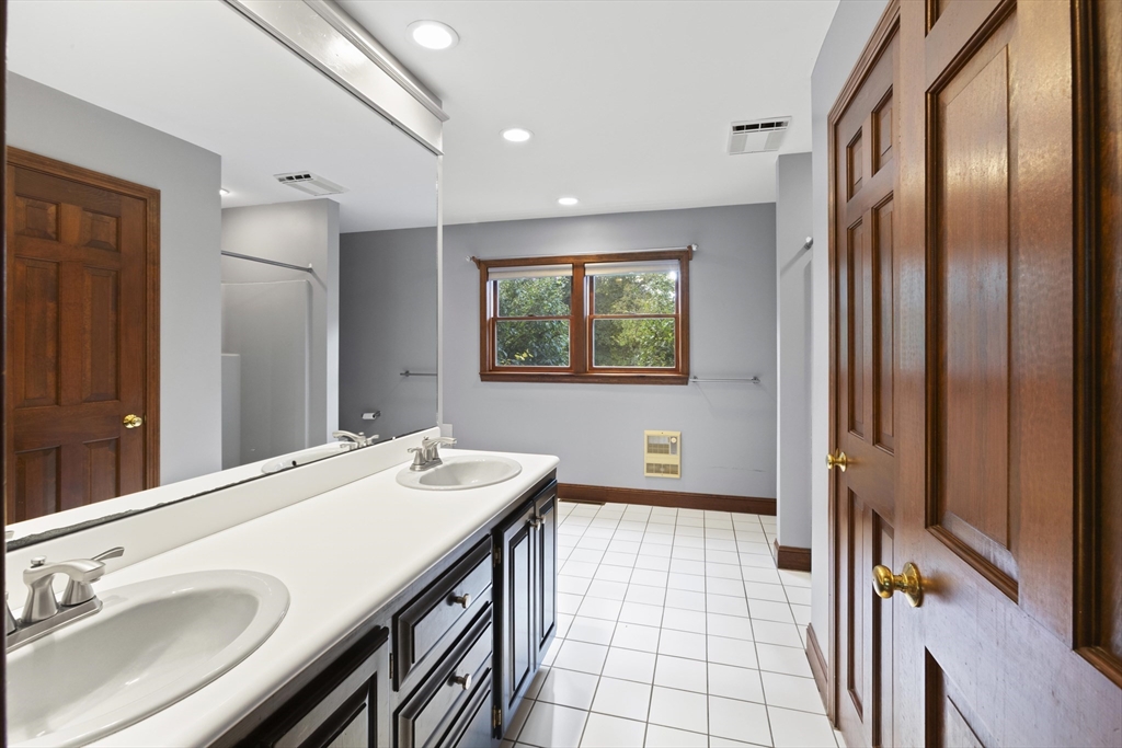 152 Coburn Road Berlin, MA 01503 - Photo 22 of 40 a bathroom with a sink a mirror and a shower