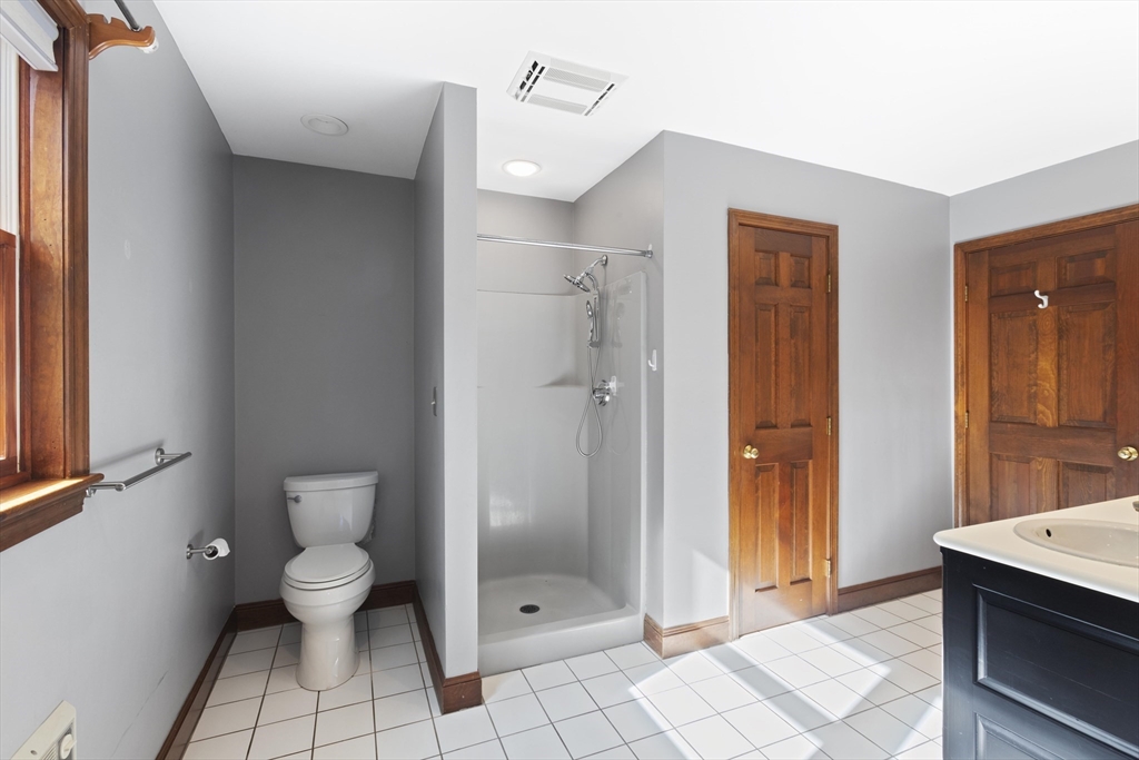 152 Coburn Road Berlin, MA 01503 - Photo 24 of 40 a bathroom with a granite countertop shower a toilet and a sink