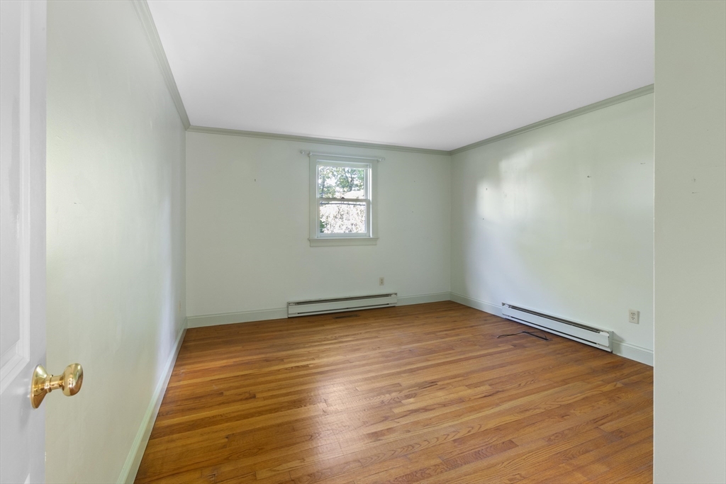 152 Coburn Road Berlin, MA 01503 - Photo 25 of 40 an empty room with wooden floor and windows