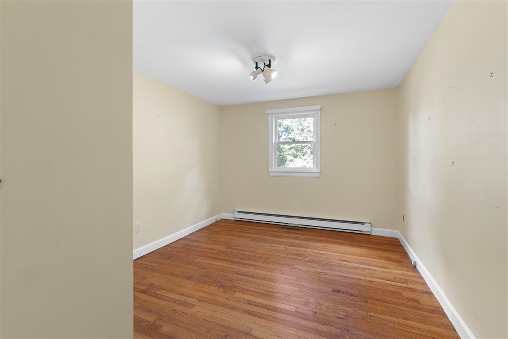 152 Coburn Road Berlin, MA 01503 - Photo 27 of 40 an empty room with wooden floor and windows