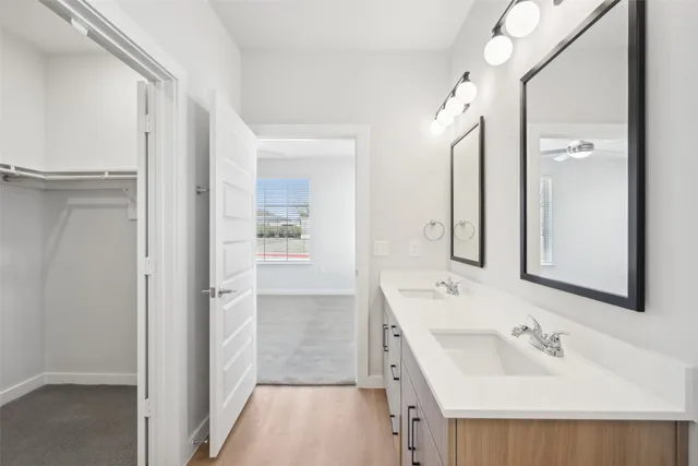 a bathroom with a sink a mirror and a shower