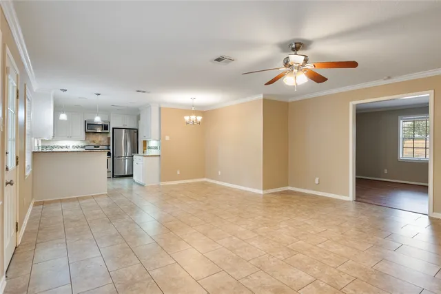 a view of a kitchen with a sink and a chandelier fan