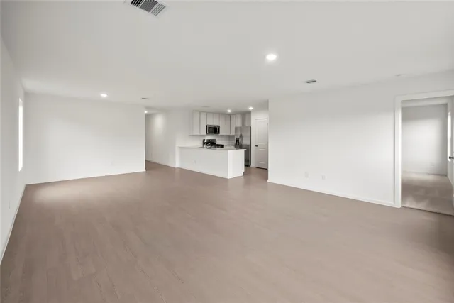a view of kitchen with kitchen island sink stainless steel appliances and cabinets