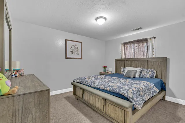 a bedroom with a bed and cabinet