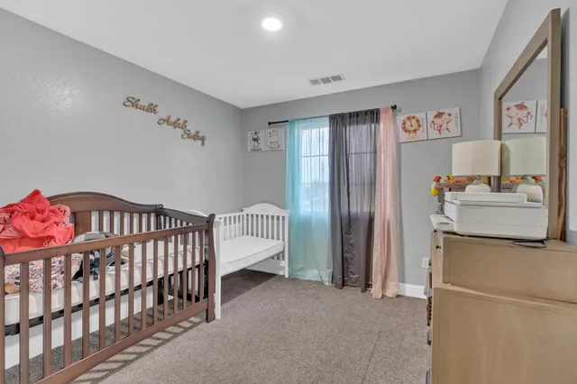 a bedroom with furniture and a window