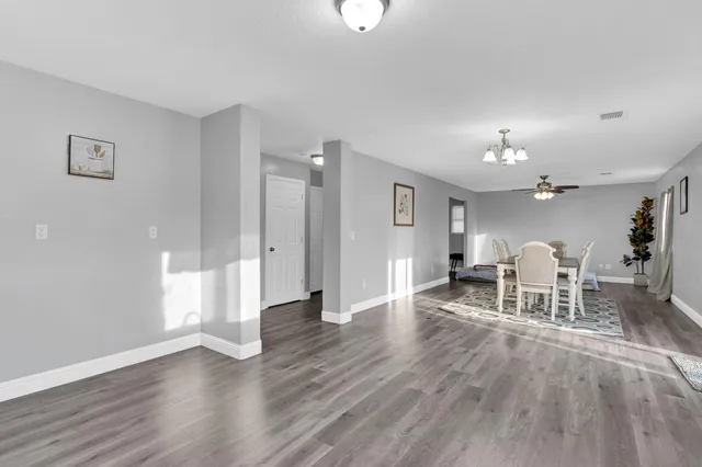 a view of a livingroom with furniture and a table chairs