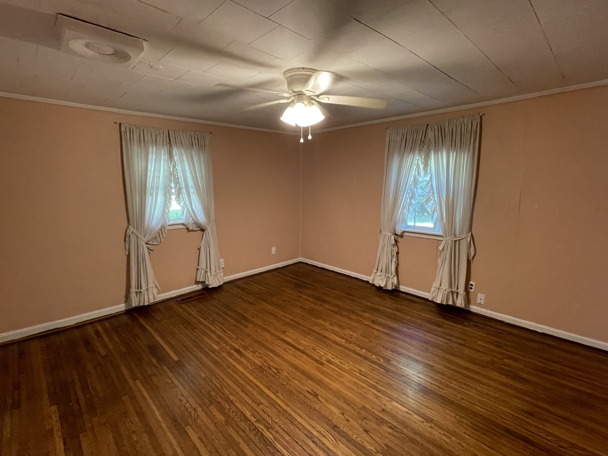 630 Pruett Road Dickson, TN 37055 - Photo 8 of 24 an empty room with wooden floor chandelier fan and windows