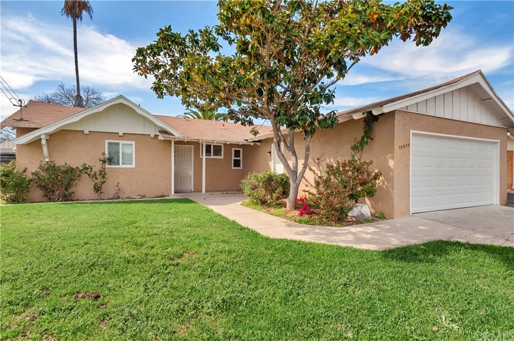 13030 Morene Street Poway, CA 92064 - Photo 1 of 1 a view of a yard in front of a house with plants and large tree