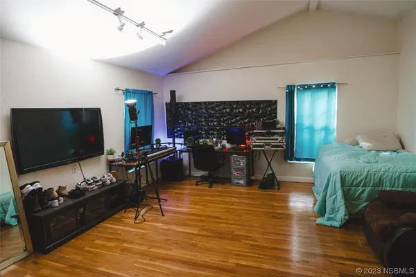 a bedroom with a bed and a flat screen tv