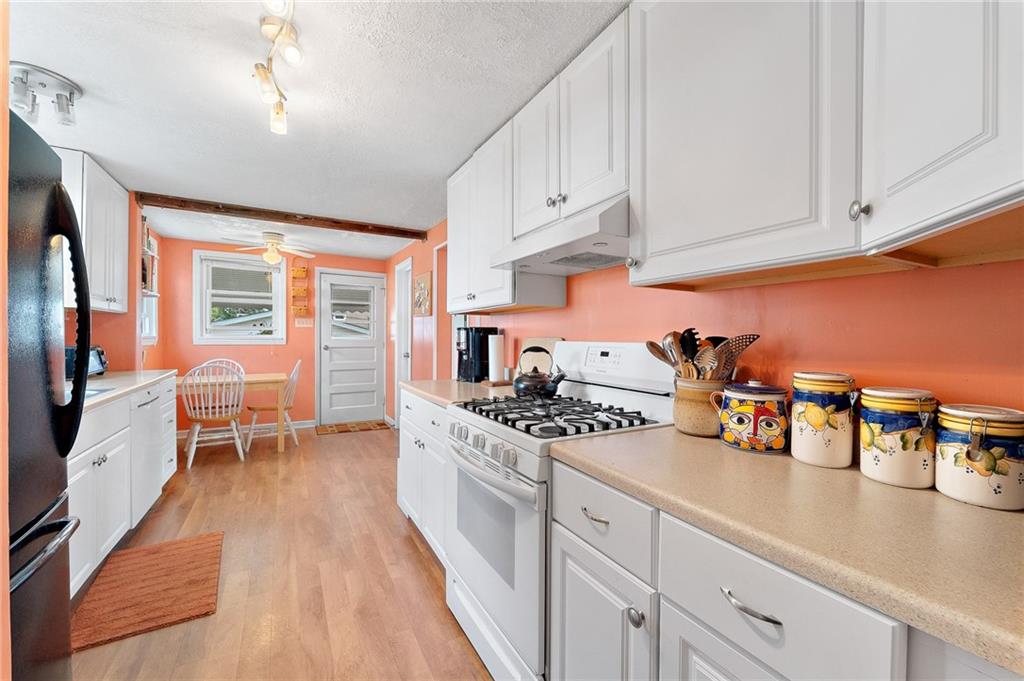 124 5th Street McDonald, PA 15057 - Photo 13 of 24 a kitchen with stainless steel appliances a stove a sink and white cabinets