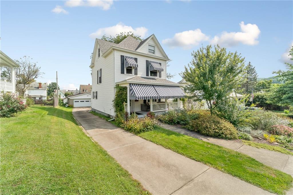 124 5th Street McDonald, PA 15057 - Photo 2 of 24 a front view of a house with a yard and garage