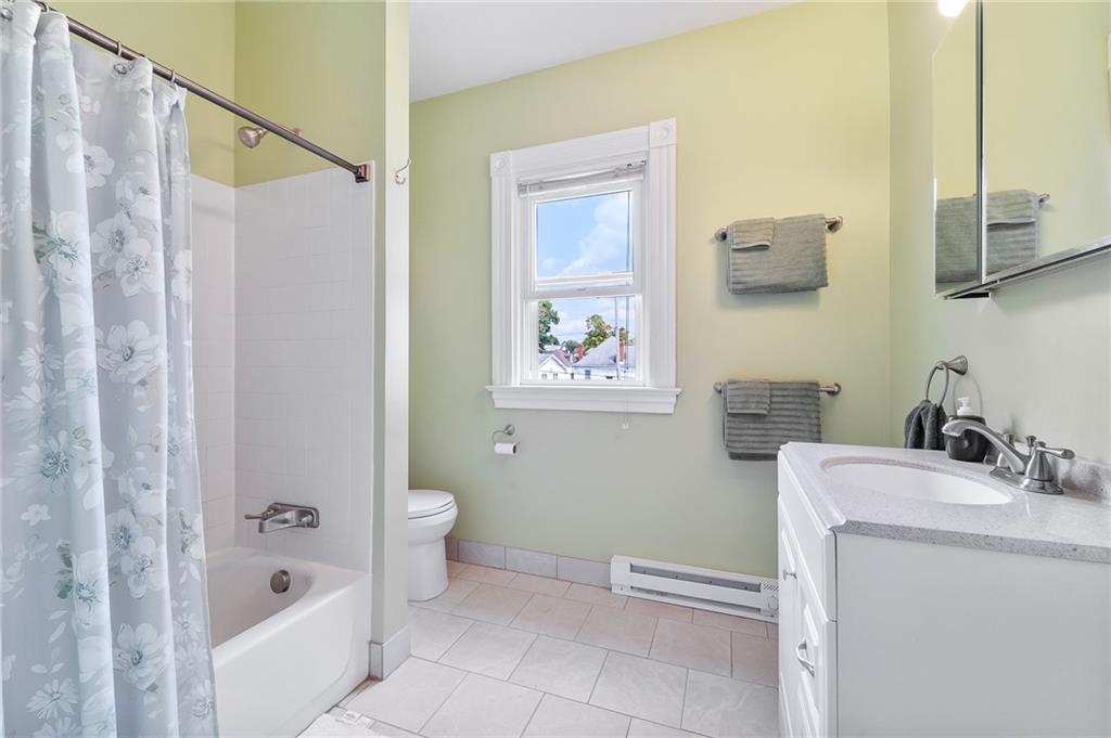 124 5th Street McDonald, PA 15057 - Photo 21 of 24 a bathroom with a sink a toilet and shower curtain
