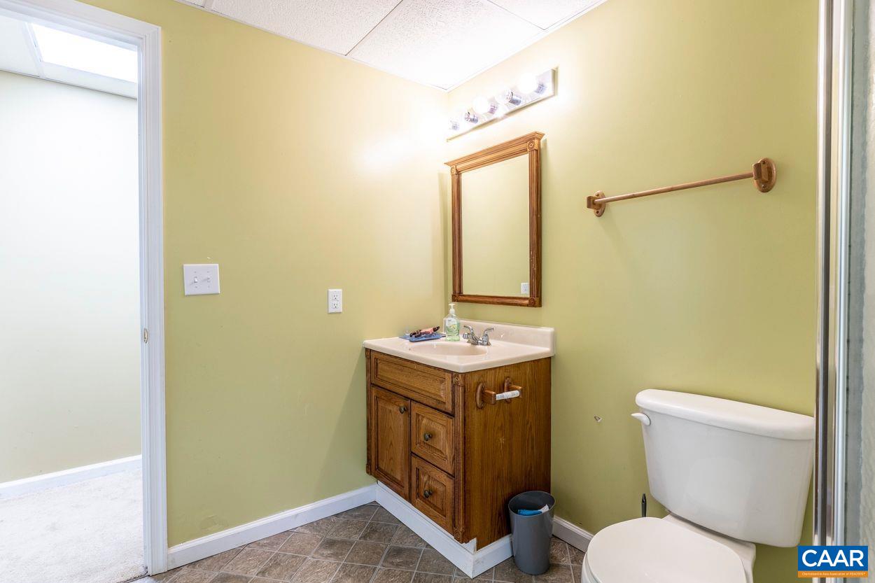 212 Petunia Road Ruckersville, VA 22968 - Photo 20 of 32 a bathroom with a granite countertop toilet and a sink