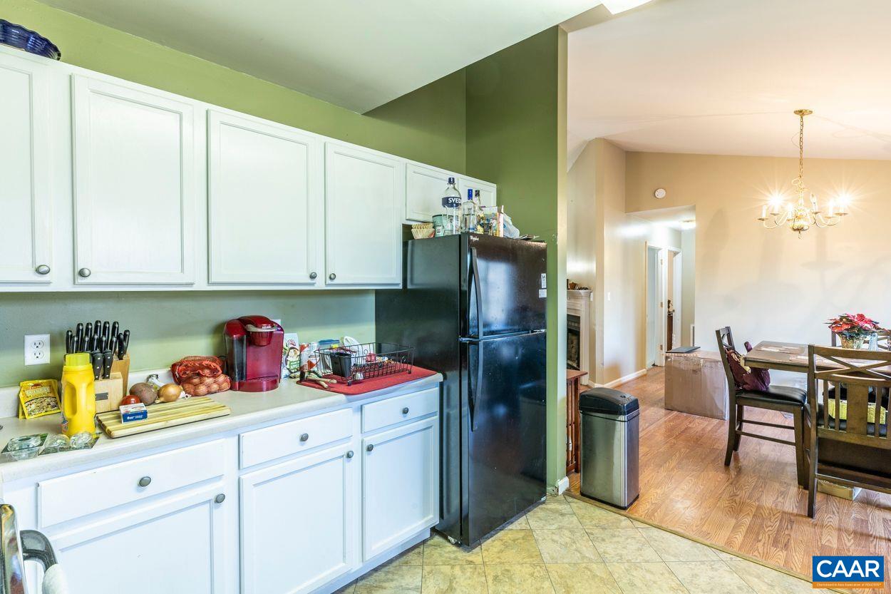 212 Petunia Road Ruckersville, VA 22968 - Photo 32 of 32 a kitchen with stainless steel appliances granite countertop a refrigerator a sink dishwasher and white cabinets with wooden floor