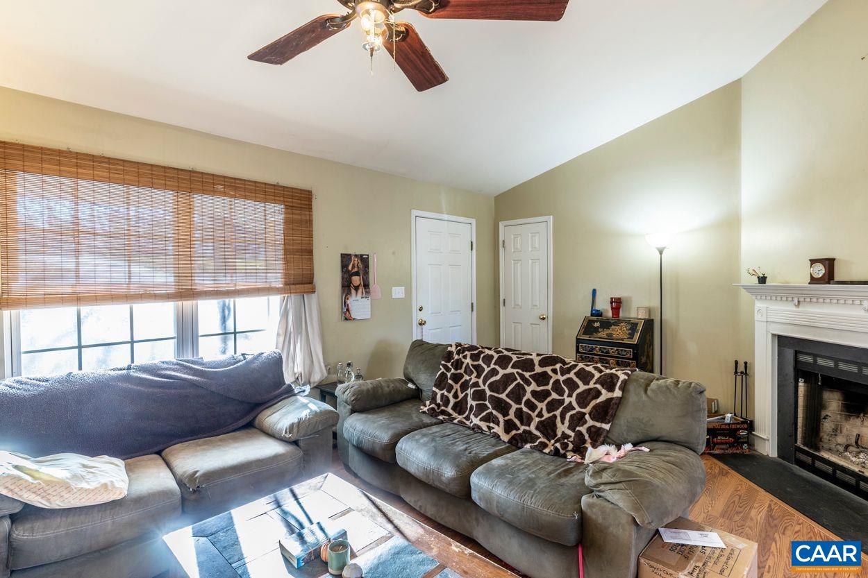 212 Petunia Road Ruckersville, VA 22968 - Photo 5 of 32 a living room with furniture fireplace and a large window
