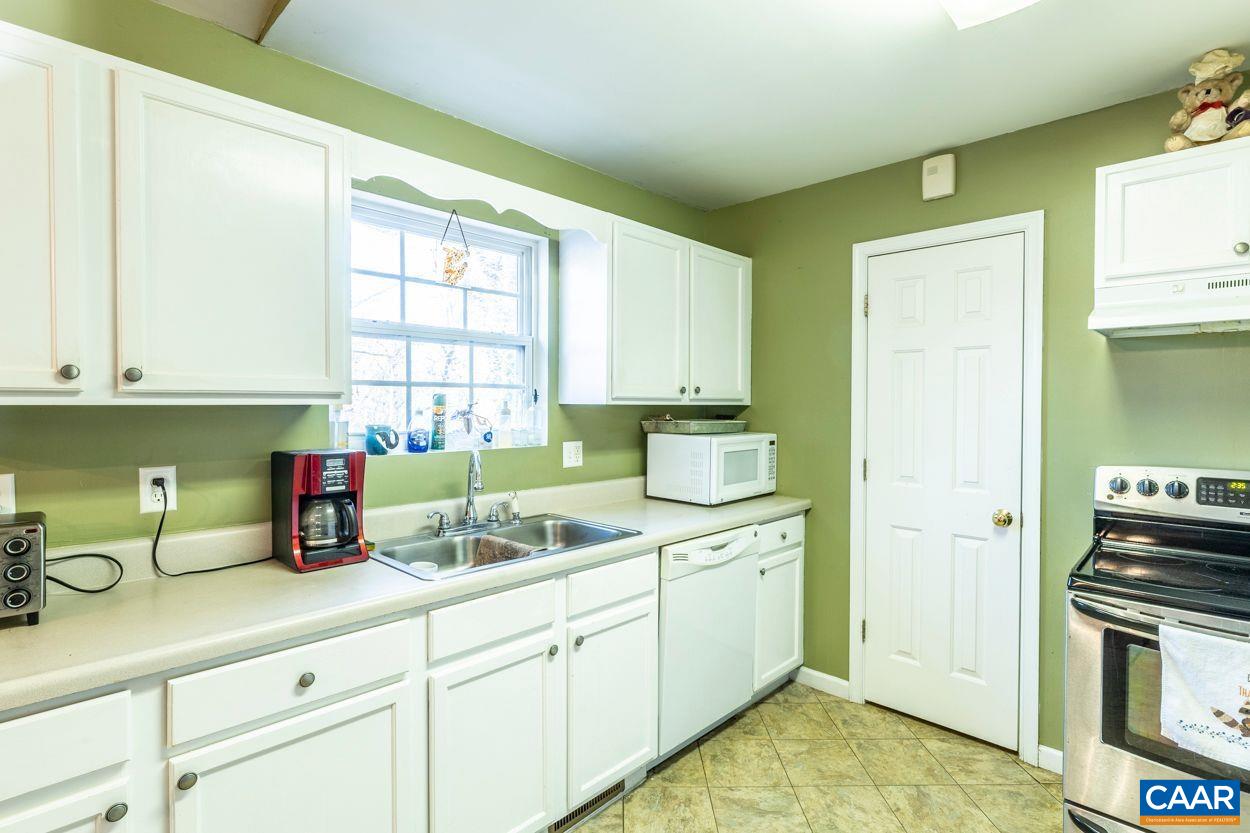 212 Petunia Road Ruckersville, VA 22968 - Photo 10 of 32 a kitchen with a sink cabinets and window