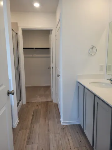 a view of walk in closet with wooden floor
