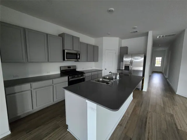 a kitchen with sink and cabinets