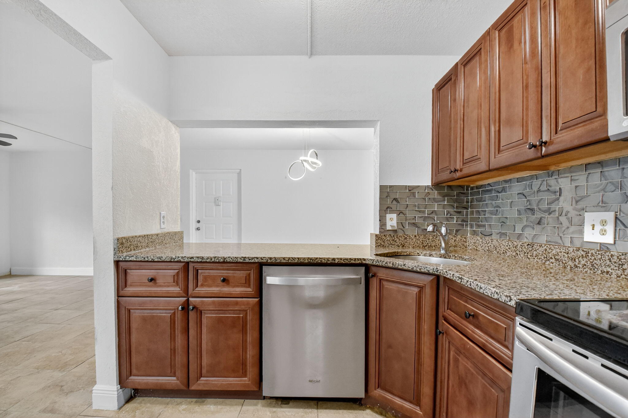 208 Foxtail Drive, Unit B2 Greenacres, FL 33415 - Photo 11 of 33 a kitchen with cabinets appliances and a counter space