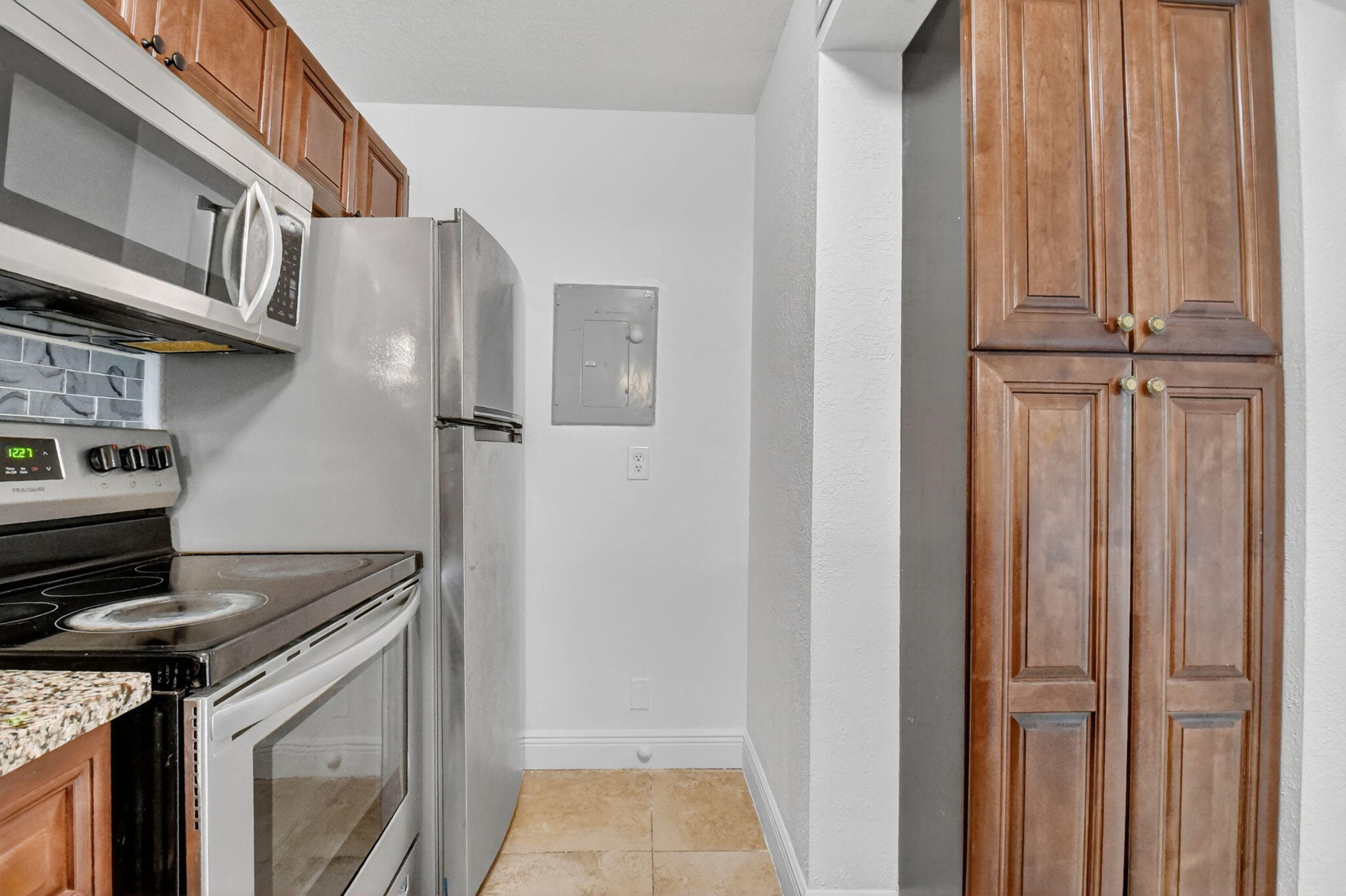 208 Foxtail Drive, Unit B2 Greenacres, FL 33415 - Photo 15 of 33 a kitchen with stainless steel appliances granite countertop a refrigerator and a stove